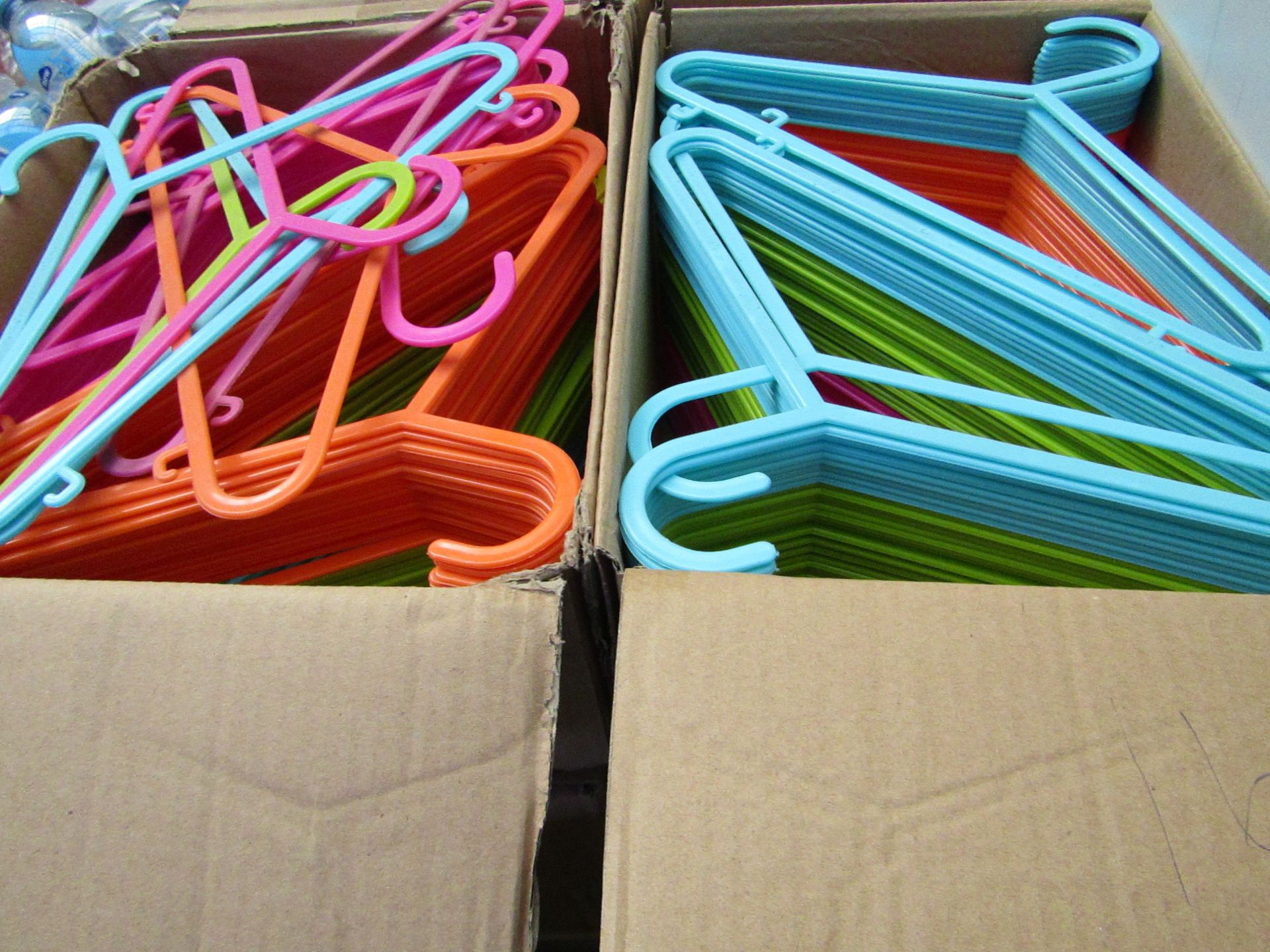 Box of Approx 50 kids Colourful plastic coat hangers.New & boxed