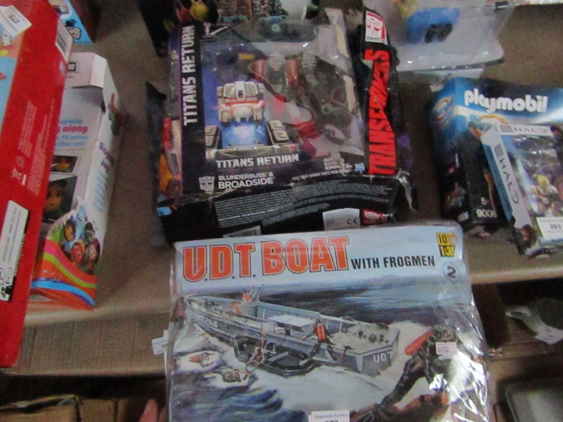 2x Items being a Revell UDT model boat set and a Transformers toy.