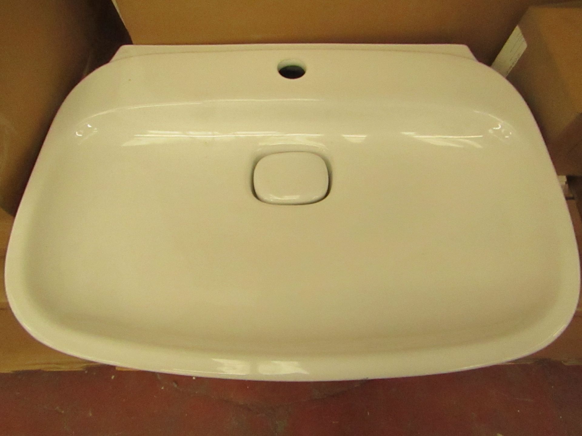 Laufen made 600mm 1 tap Hole sink with porcelain drain cover, new and boxed.