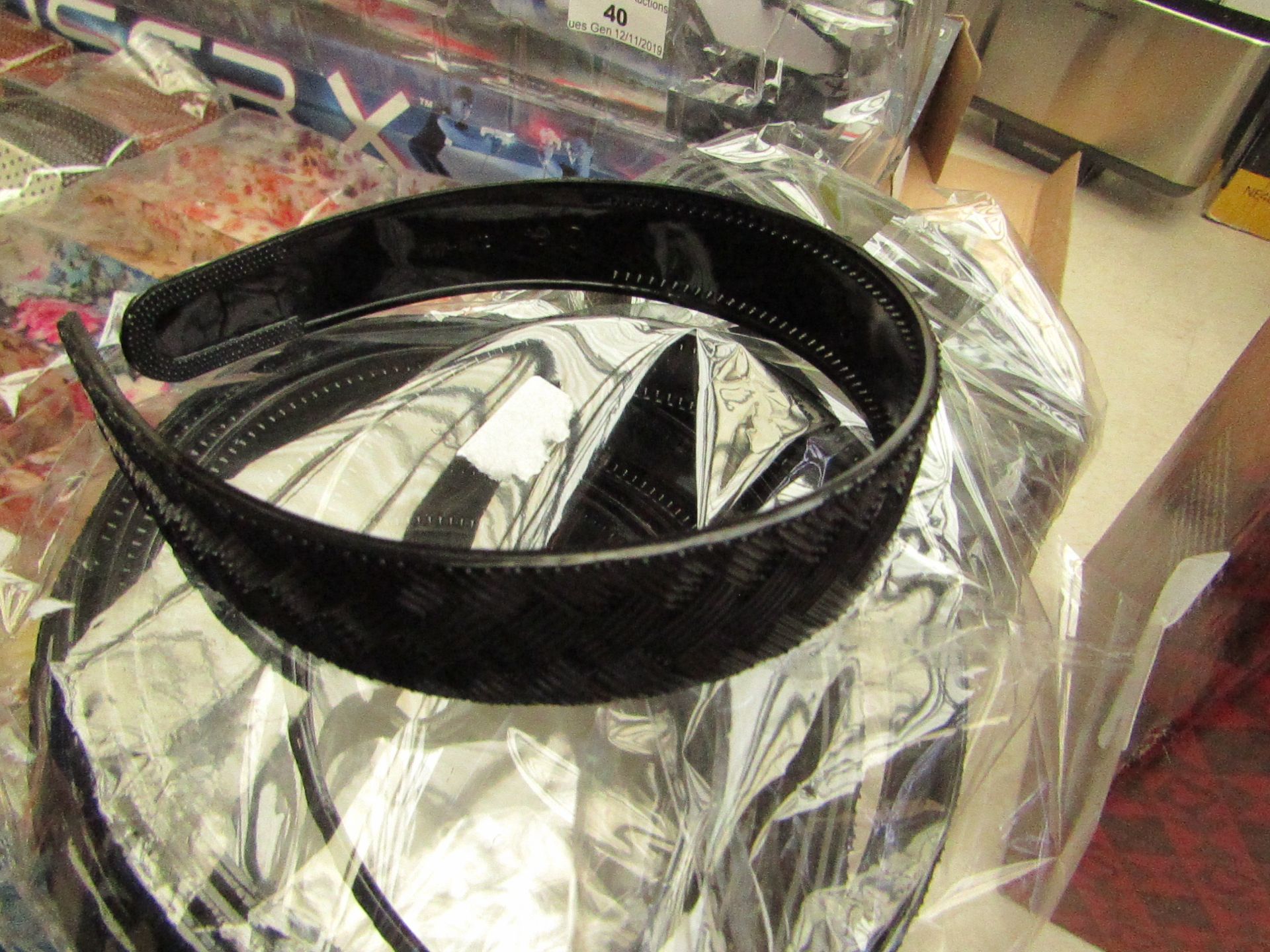 12x Black headbands, see picture for design, new in packaging.