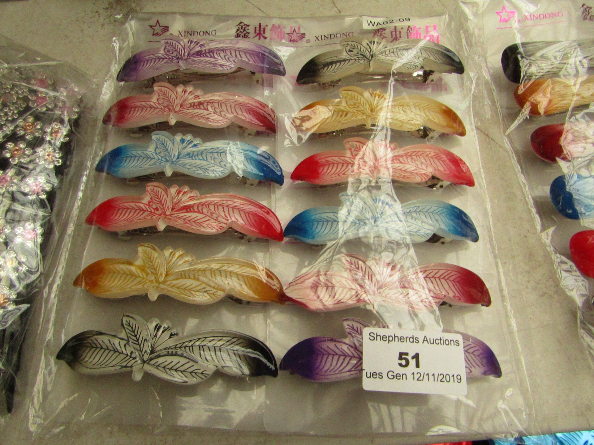 12x Hairs clips, see picture for design, new and packaged.