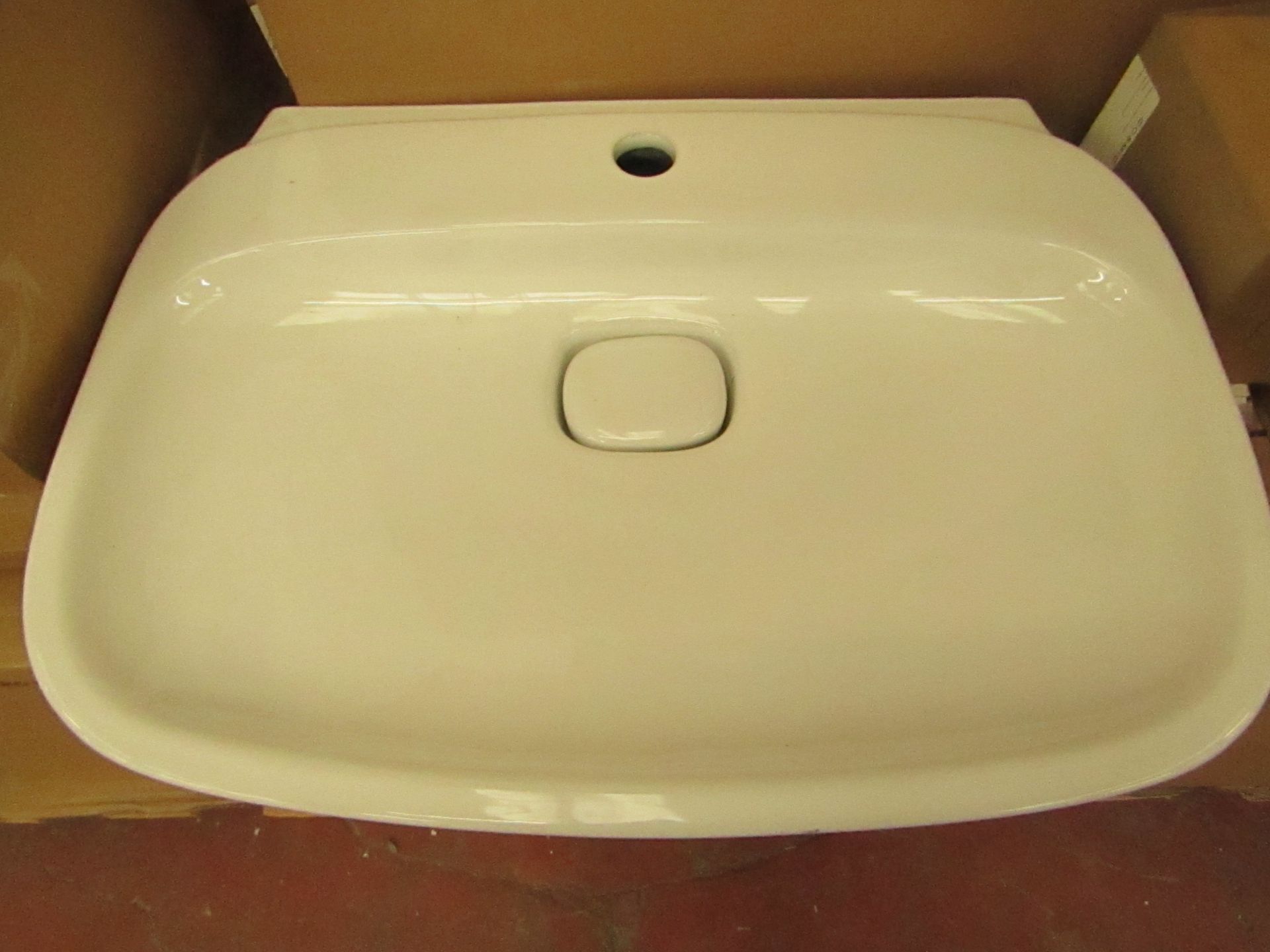 Laufen made 600mm 1 tap Hole sink with porcelain drain cover, new and boxed.