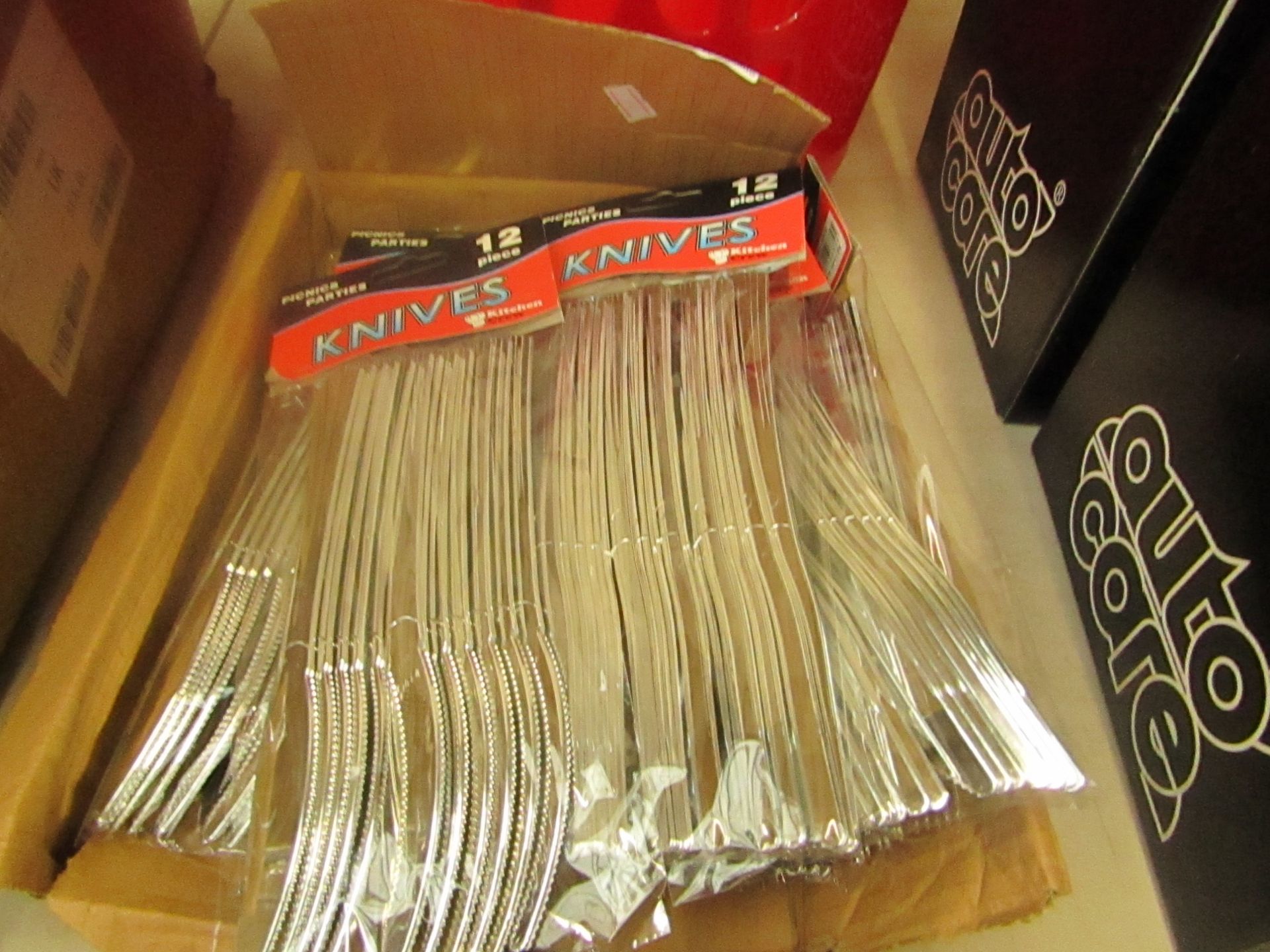 Approx 18 packs of plastic knifes 12 per pack - all packaged and boxed.