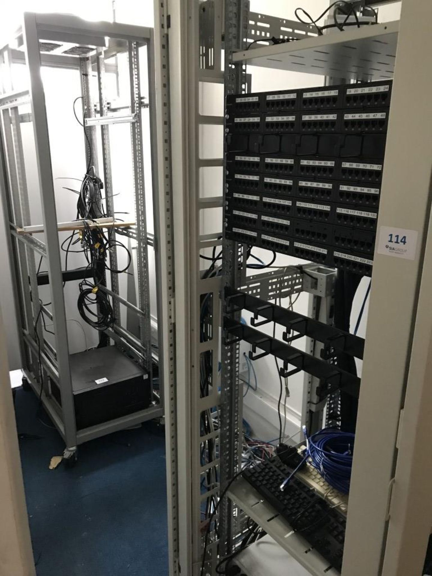 (2) Full height comms racks including (7) 24 port patch panels