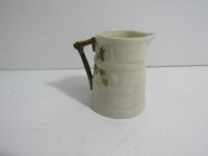 Royal Worcester bark-effect cream jug with a small bird design