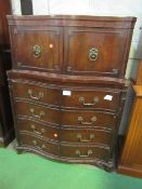 Mahogany serpentine fronted chest of 4 drawers with small linen press above. Heavy brass mounts.