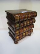 Small chest of 4 drawers in the form of a stack of books, 33cms high. Estimate £20-30.