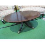 Mahogany oval top coffee table on centre pedestal to casters, 112cms x 67cms x 48cms. Estimate £10-