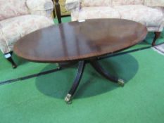 Mahogany oval top coffee table on centre pedestal to casters, 112cms x 67cms x 48cms. Estimate £10-