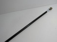 Black malacca cane with silver hallmarked top. Estimate £10-20.