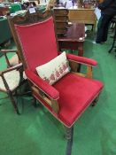 Oak framed upholstered open armchair on casters c/w small tapestry cushion. Estimate £30-50.