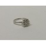 18ct diamond cluster ring approx 0.75ct of diamonds size L wt 3.1g. Estimate £450-550