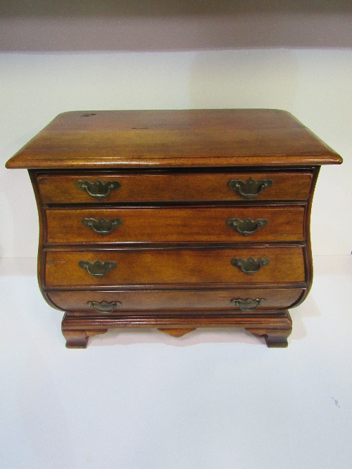 Miniature 'bombe' style mahogany chest of 4 drawers. Estimate £40-60.