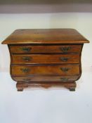 Miniature 'bombe' style mahogany chest of 4 drawers. Estimate £40-60.