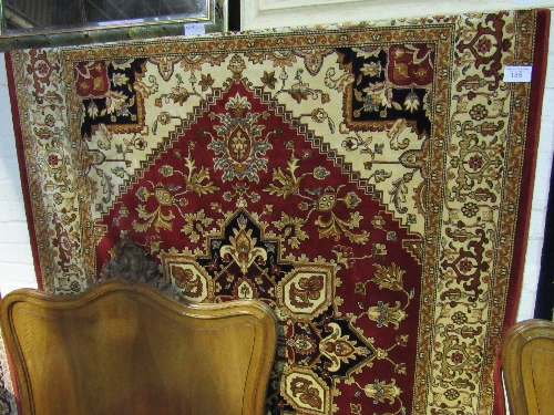 Red ground Heriz carpet size 2.30 x 1.60. Estimate £70-90.