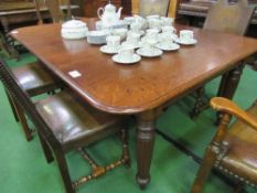 Mahogany dining table on 8 reeded tapered legs & casters, 176cms x 135cms x 72cms. Estimate £50-80.