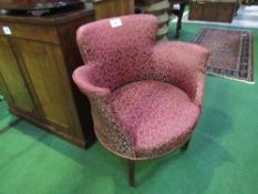 Upholstered tub chair on casters. Estimate £50-60.