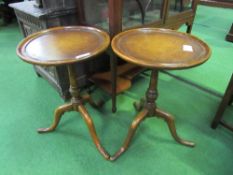 Pair of mahogany pedestal tables with leather insets, diameter 44cms, height 66cms.