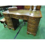 Mahogany serpentine fronted knee-hole desk with leather inset, 115cms x 76cms x 52cms.