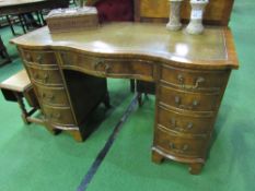 Mahogany serpentine fronted knee-hole desk with leather inset, 115cms x 76cms x 52cms.