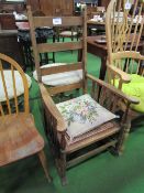 Cane seat ladder back rocking chair. Estimate £20-30.