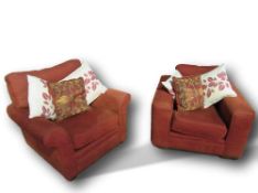 Pair of rust coloured easy chairs & cushions. Estimate £50-60.