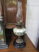 Oil table lamp complete with chimney, height 55cms. Estimate £20-30.