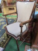 Walnut padded elbow chair with serpentine back & rolled edges. Estimate £10-20.