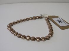 Swarovski pearls with a silver clasp. Estimate £25-35