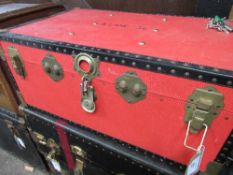 Red coloured travel trunk. Estimate £10-20.