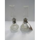 Pair of glass oil lamps. Estimate £10-20.