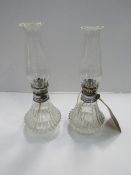 Pair of glass oil lamps. Estimate £10-20.