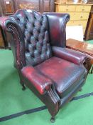 Winged Chesterfield-style button-back Ox blood leather armchair. Estimate £50-70.