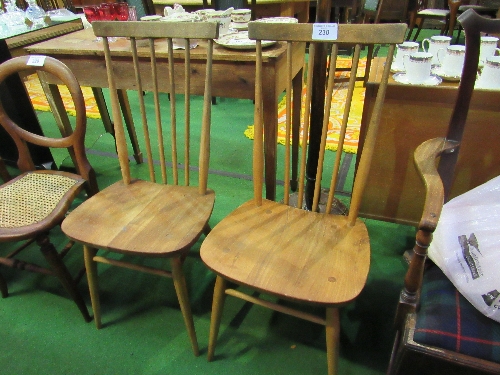 Pair of vintage Ercol spindle back armchairs in elm. Estimate £20-30.