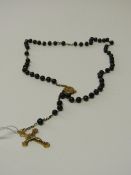 Rosary bead necklace. Estimate £30-40.