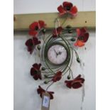 Poppy wall hanging clock. Estimate £5-10.