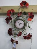 Poppy wall hanging clock. Estimate £5-10.