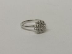 18ct diamond cluster ring approx 0.75ct of diamonds size L wt 3.1g. Estimate £450-550
