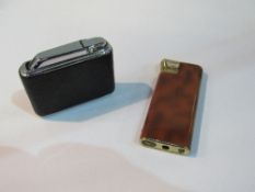 2 Colibri monogas lighters & a brown enamel electric. Estimate £10-20.