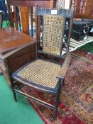 Edwardian high backed elbow chair with bergere cane seat. Estimate £15-20.