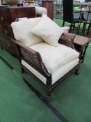 Bergere armchair with cream upholstered seat & matching cushions. Estimate £50-80.