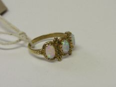 Gold plated silver ring set with 3 simulated opals. Size N1/2. Estimate £20-30.