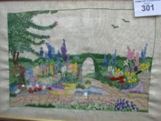 Framed & glazed embroidery of a cottage garden scene. Estimate £10-15.