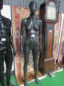 Pose-able female mannequin on glass stand. Estimate £20-40.