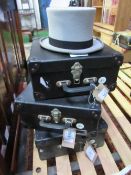 3 boxed grey top hats. Estimate £15-20.