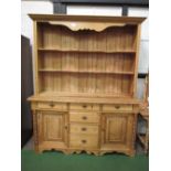 Large pine dresser with shape fronted shelves, 180cms x 50cms x 220cms. Estimate £100-200.