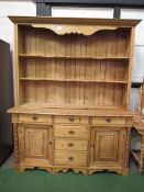 Large pine dresser with shape fronted shelves, 180cms x 50cms x 220cms. Estimate £100-200.