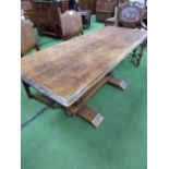 Oak dining table on carved pedestals to stretcher, 170cms x 70cms x 70cms. Estimate £30-50.