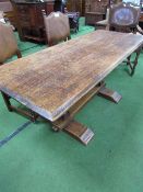 Oak dining table on carved pedestals to stretcher, 170cms x 70cms x 70cms. Estimate £30-50.