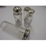 4 various glass dressing table pots with silver lids, London 1931, 1881, 1912 & 1919. Estimate £30-